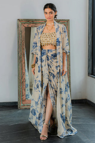 Our garden of bloom jacket set makes your day bloom with its gathered dhoti skirt and romantic long jacket with poetic sleeve detailing. Handmade with love, the blouse features dainty hand-tucked kaudi shells and coin detailing. A perfect dress for outdoor gardern parties, festivities traditional and cermonial events, brunch gatherings and various other ocassions.