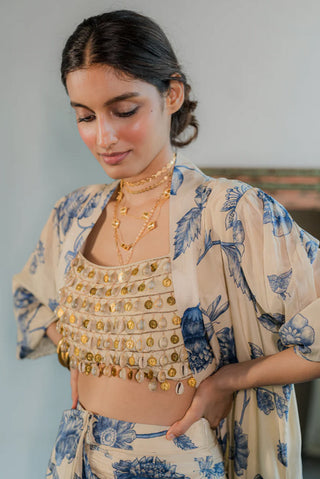 The close up of handmade with love, the blouse features dainty hand-tucked kaudi shells and coin detailing.