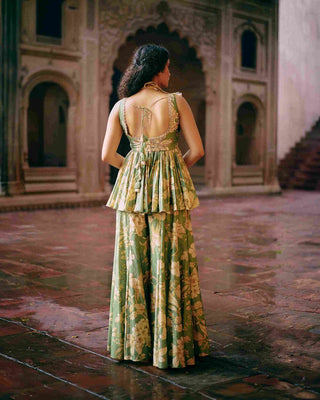 Back look of Green maeve peplum featuring Paulmi And Harsh signature Roop flip bird print. The yoke and back are hand-embroidered. It is paired with printed flared palazzos. Indian ethnic women's wear perfect for parties, wedding, events, cocktail.