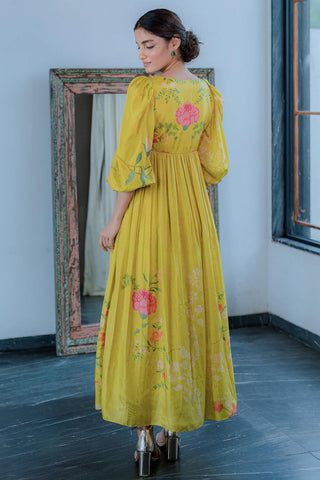 Back look of Yellow Floral Maxi Gown Dress with ruffle sleeve. The pink florals add a pop of color to this beautiful silhouette. It is adorned with hand–highlighted flowers on the yoke.