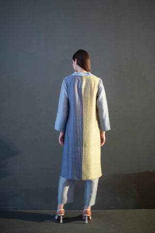 A two piece dupion silk set comprised of abstract geometric and floral print in playful color compositions and parallel pants with fusion textiles.