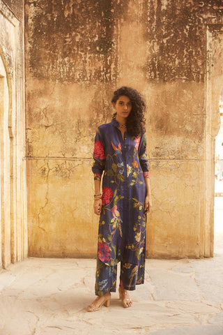 A blooming blue, red and ivory floral printed kurta set tailored from placement printed silk habutai fabric. The kurta has a button front placket with shirt collar, long sleeves and side slits. It is teamed with straight cut pants. This chic and versatile silhoutte can be passed down from one generation to another.