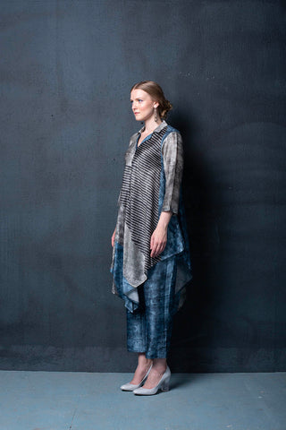 A two piece dupion silk set comprised of geometrical abstract print, asymmetrical hemline and parallel pants with fusion textile play of abstract print. 