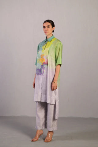 High-low linen silk kurta set in neon blue and green styled for evening gatherings, offering a contemporary silhouette with pleats, point collar, and watercolour print finish.