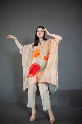 A two piece dupion silk set comprised of abstract geometric and floral print in playful color compositions and parallel pants with fusion textiles. Designed by clos.