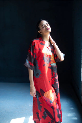 Model in Abstract print dupion silk kurta set standing near window. It is a perfect for evening events, kitty party, formal occasions and cultural gatherings.