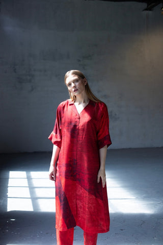 Model wearing red abstract print straight kurta with half collar and matching parallel pants, modern ethnic ensemble. Designed by Clos. 