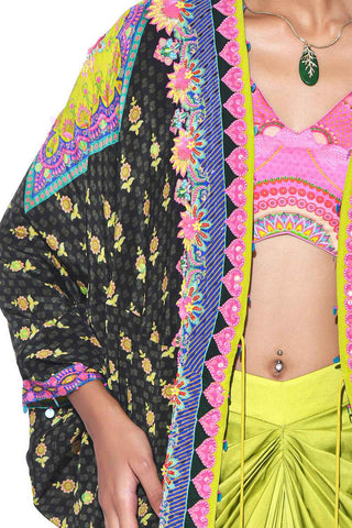 Detailed hand embroidered on dark olive shrug and pink sleeveless blouse.