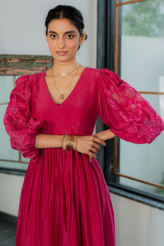 Model wearing a flowy resort pink maxi dress with a relaxed yet elegant silhouette, perfect for beach vacations, brunch with friends, or sunset soirees. The dress features soft, breathable fabric with a flattering drape, ideal for day-to-night transitions.