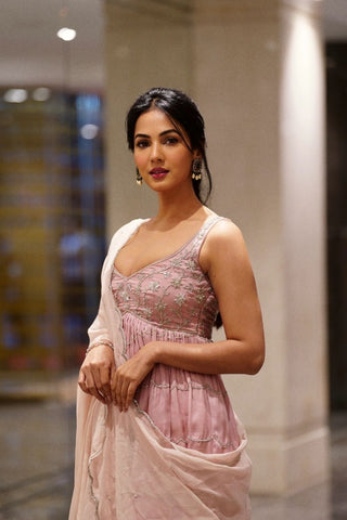 Designer baby pink peplum set featuring detailed silver embroidery, scallop hem, two-tone sharara, and embroidered dupatta with butti design. Festive wear elegant ethnic outfits for women. Designed by Ease.