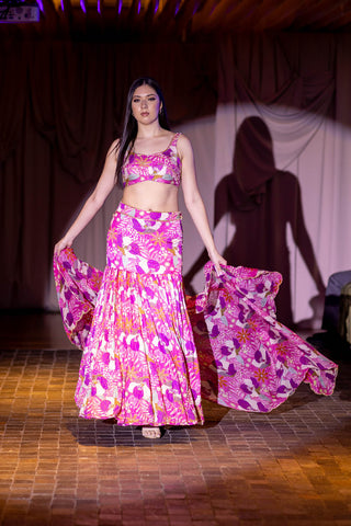 Ethnic Glamour on International Stage. Indian Designers at Australia Fashion Week. Model walking the runway in a Fuchsia floral printed lehenga and a sleeveless blouse at Australian Fashion Grandeur.