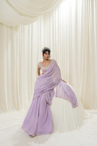 Featuring Lavender pre–stitched saree set paired with a satin organza hand–embroidered blouse in stripes print. Designed by Ease.