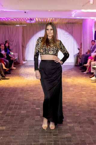 Model flaunting a bold printed co-ord set with crop top with cowl skirt at Australian Fashion Grandeur runway.