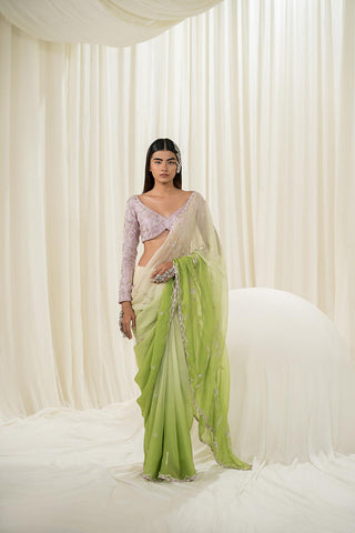 Featuring an Off white-parrot green ombre saree embroidered in sliver heavy jaal paired with a full sleeve blouse. A design by Ease.