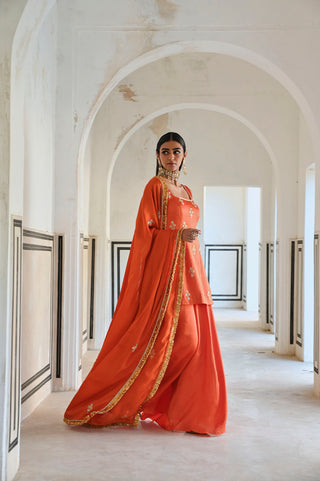 Square neckline orange butti embroidered short designer kurta palazzo set for women. Designed by Ease.
