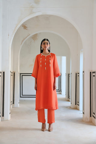 front view of orange kurta set, premium fabrics with intricate handwork, vibrant hues. Designed by Ease.
