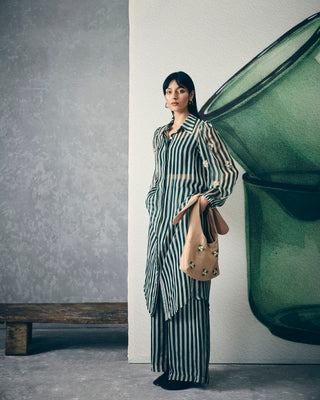 Stylish emerald green striped organza kurta with embroidered detailing, paired with bustier and matching pants, modern women’s Indo-western outfit suitable for parties and festive wear.