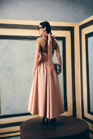 Contemporary pink summer dress with halter neck tie-up, backless design, and delicate floral print on soft poplin fabric.