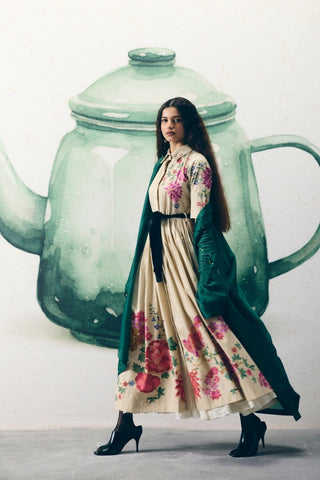 Contemporary ivory shirt dress crafted in soft poplin fabric with tie-up belt and refined floral placement embroidery.