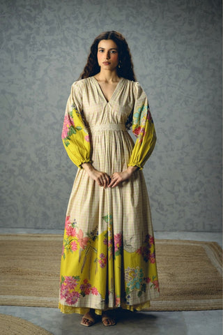 Elena Dress in ivory poplin featuring a vibrant floral print with bold yellow accents, airy puff sleeves, and a flattering fitted bodice and waist. This elegant women's dress offers timeless style for brunches, vacations, garden parties, and summer occasions.