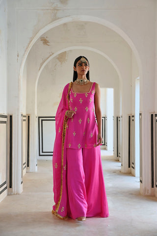 Bright pink floral embroidered short ethnic kurta with palazzo and dupatta, perfect for festive wear. Designed by Ease