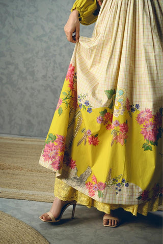 Close up of Elena floral dress featuring an ivory base with bold yellow botanical prints, soft puff sleeves, and a flattering regular-fit silhouette. A sophisticated designer dress perfect for casual outings, resort wear, and special occasions.