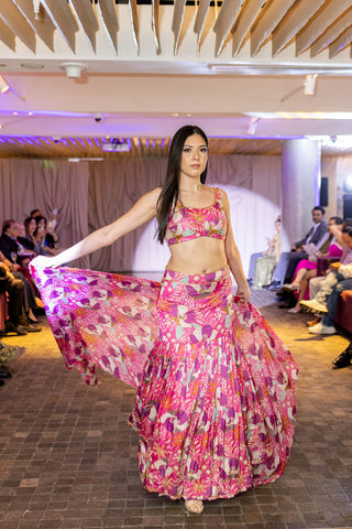 Ethnic Glamour on International Stage. Model walking the runway in a Fuchsia floral printed lehenga and a sleeveless blouse at Australia Fashion Grandeur.