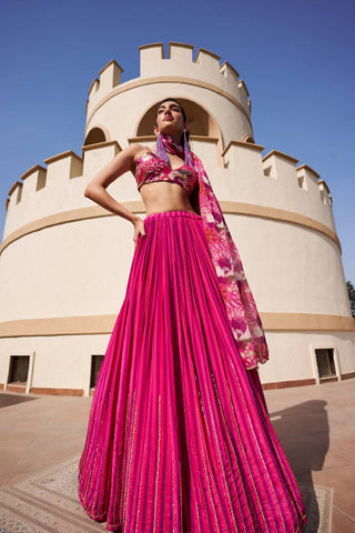 Fuschia and purple stripes lehenga, embroidered with nakshi line technique all over, paired with floral printed and embroidered blouse and floral printed organza dupatta with embroidery on the edge. Designed by Ease.