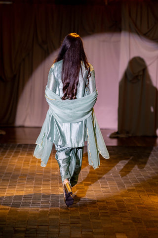 Back shot of Model in Turquoise blue embroidered short kurta with dhoti and dupatta at Australian Fashion Grandeur Show.