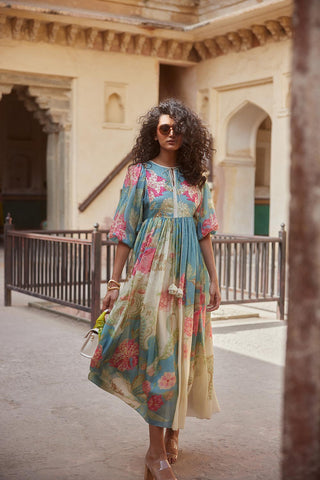 An ivory with multicoloured floral print placement maxi dress, crafted from smooth and breathable habutai silk and embroidered with baby-flowers and pearls along with self–thread french knot detailing.