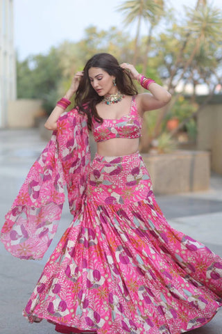Fuchsia floral printed lehenga with embroidered bottom , paired with raw satin printed blouse embroidered all over and floral printed organza dupatta, with scallop embroidery on the edge.