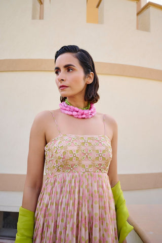 Detailed close-up of the contemporary geometric print and embroidery and premium fabric on the Ease pink and lime green Anarkali dress.