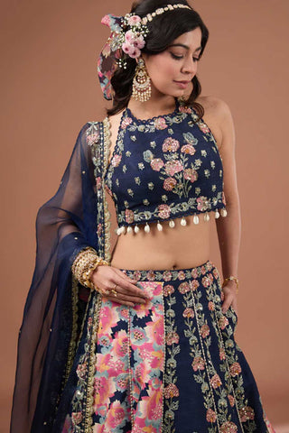 The close up look of the embroidered indigo silk blouse with halter neckline. It comes with an indigo embroidered organza dupatta.