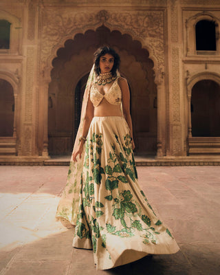 A close up look of green floral print on lehenga, featuring intricate hand-embroidery in aari, zardozi and sequins.
