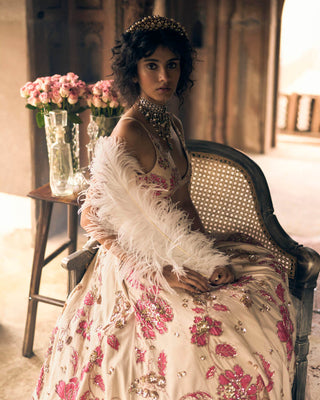 A close up look of the lehenga in ivory base and pink floral print lehenga, featuring intricate hand-embroidery in aari, zardozi and sequins