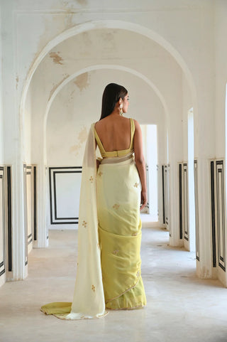 Back look of the matching silk blouse paired with the ivory-olive ombre saree.