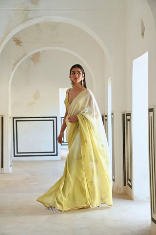 Ivory to olive green ombre saree in georgette with floral butti embroidery, paired with a silk blouse for a festive contemporary look.