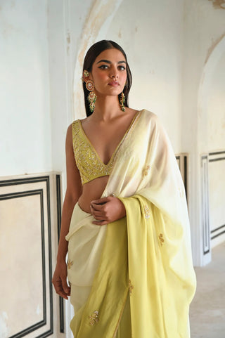 Ivory-olive ombre saree adorned with floral butti embroidery and paired with a blouse, designed for sophisticated festive dressing, celebrations and elegant occasions.