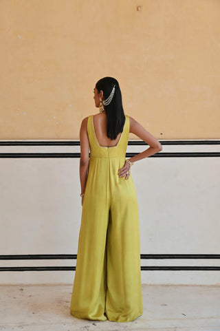 Back look of Full-length styled look of the lime jumpsuit, a festive statement piece in silk.