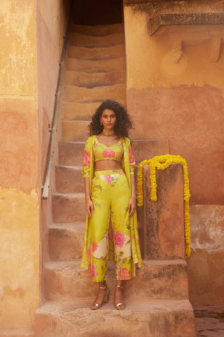 A lime yellow robe jacket set in a cheerful and fresh color combination. The blouse is hand–embroidered with delicate highlights. Pair this easy set with a stack of gold chunky jewellery and you are ready to go for modern haldi day on a hot summer morning.