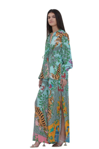 Right-side view of the designer summer co-ord set showing pleat accents, cuff-tie sleeves, all-over Gond prints, and flowy flared trousers with a subtle slit — ideal for resort, beach, and holiday styling.