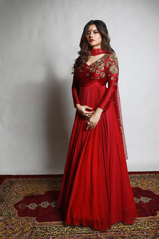 Featuring an Anarkali with a yoke embroidered with intricately designed Chakra motifs attached to kalis in varied shades of Red and Rani Pink. Designed by Mona and Vishu.