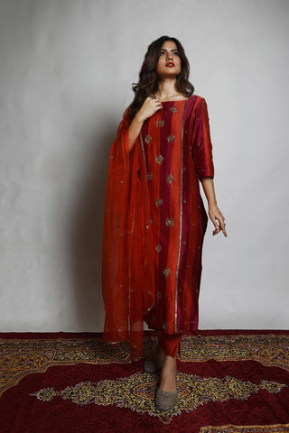 Featuring a straight Patchwork Kurta embroidered with intricately designed motifs. Paired with matching Narrow Pants and an embroidered Dupatta. Designed by Mona and Vishu.