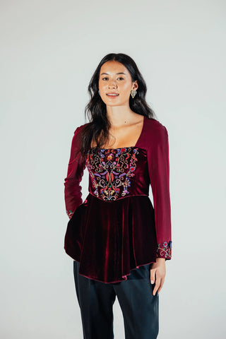 Sasha waist-defining blouse by Musou featuring a feminine shaped silhouette and polished finish, styled as an elegant separate for contemporary occasion dressing.