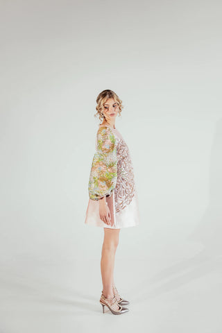 Side look of the Yuri brocade mini dress highlighting its structured shape and luxurious textured fabric, creating a sophisticated statement look for modern occasion dressing.
