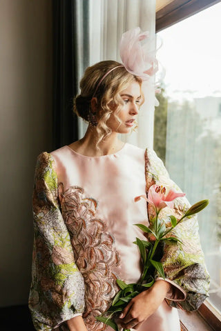 Yuri brocade mini dress by Musou featuring an elegant, structured silhouette, detailed brocade texture and statement design, styled for sophisticated occasions and modern luxury womenswear.