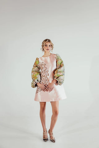 light pink mini dress styled as a sophisticated statement outfit, combining elegant proportions and textured brocade for contemporary luxury occasionwear and evening fashion.