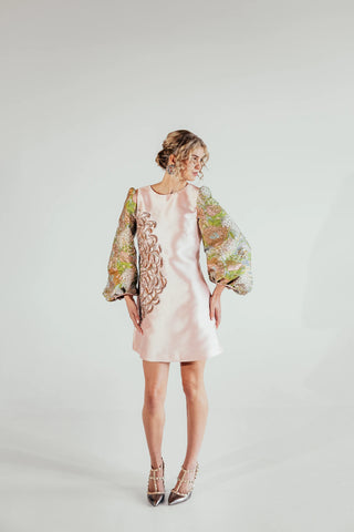 Musou featuring an elegant structured silhouette, detailed brocade texture and statement design, styled for sophisticated occasions and modern luxury womenswear.
