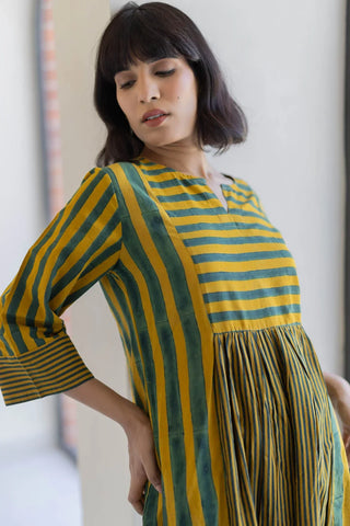 Close-up of horizontal stripe yoke, notch neckline and gathers on hand block printed mustard green kurta