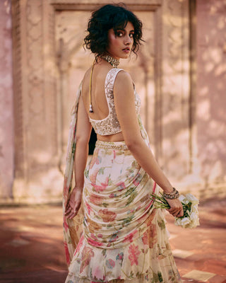 This exquisite, pre-draped saree is crafted from a light-as-air chiffon fabric and comes with an embroidered blouse. The chintz embroidered blouse is elevated with zari and aari work lending an effortless allure to this drape.